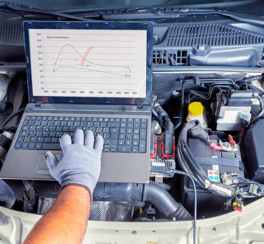 Professional car mechanic working in auto repair computer service